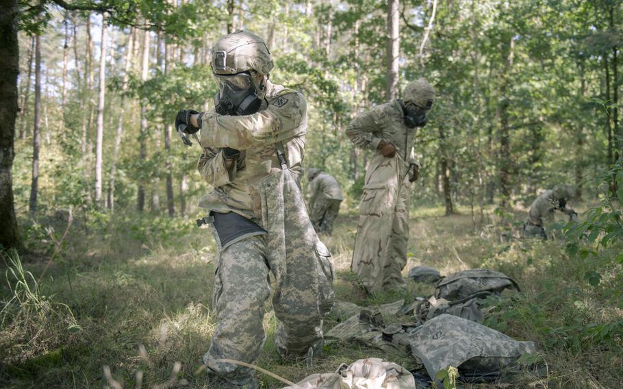 Soldiers put on protective gear.