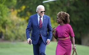 President Joe Biden walks across the South Lawn of the White House as he talks with White House press secretary Karine Jean-Pierre Thursday, May 2, 2024, in Washington, after returning from a trip to North Carolina.
