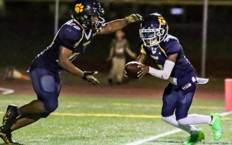 Junior running back DeShawn Baird, left, taking the handoff, rushed 57 times for 1,118 yards and 15 touchdowns in leading Guam High to a 6-1 regular-season record and also earned league offensive MVP honors in voting by coaches.