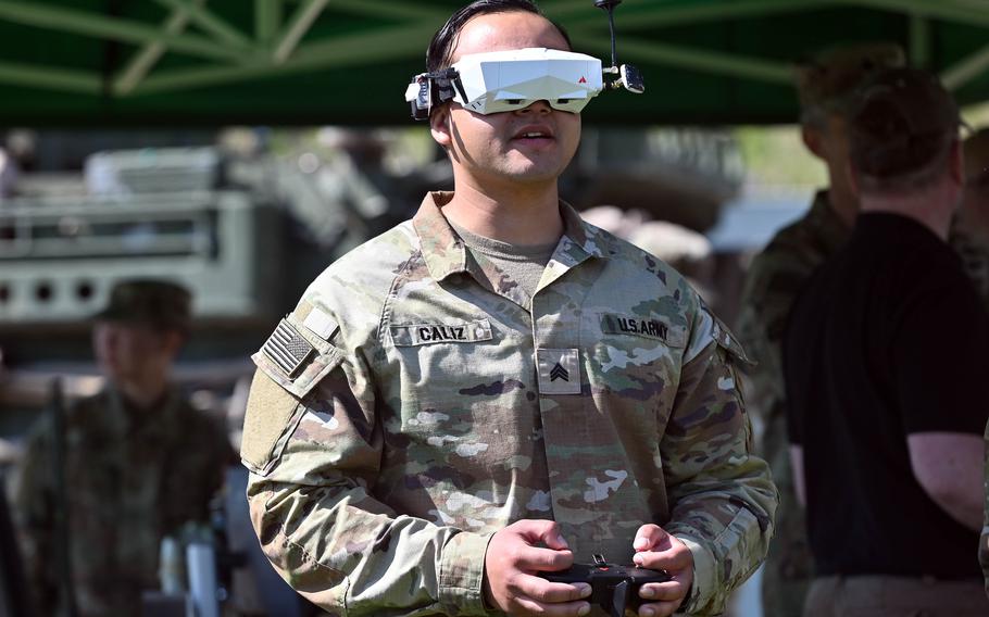 A soldier wears a virtual reality headset while piloting a first-person view drone.