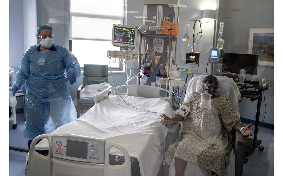 Steven Byrd, a covid-19 patient at Doctors Community Hospital, sits in a chair so his bedding can be changed.