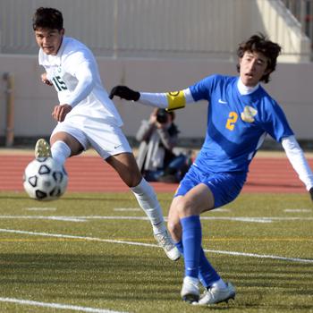 Kubasaki’s Justin Murray sends the ball past Yokota’s Tommy Vogeley during Friday’s Dragons’ 2-0 Perry Cup win over the Panthers.