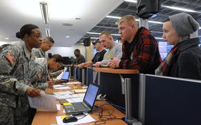 Members of the 21st Theater Sustainment Command work to process soldiers arriving at Ramstein Air Base, Germany, via the Patriot Express on Feb. 7, 2012. A Congressional watchdog in 2025 has recommended that the Defense Department overhaul the reimbursement system for permanent change of station moves to cut back on delays.