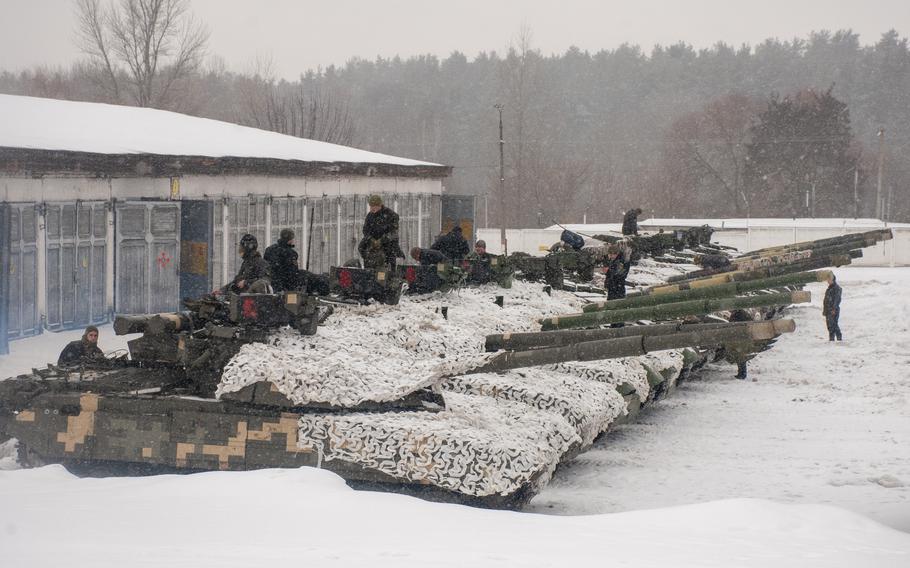 Ukrainian soldiers examine their tanks at a military unit close to Kharkiv, Ukraine, Monday, Jan. 31, 2022. 