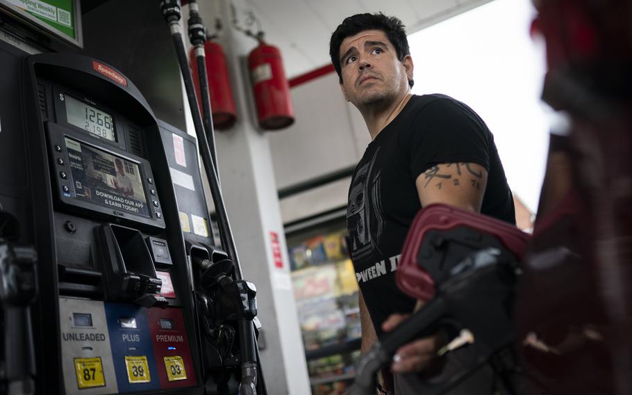 Wallace Reid fuels his vehicle he drives to make a living using ride-share apps, Wednesday, June 22, 2022, in the Queens borough of New York. Millions of Americans who rely on their cars for work are changing their habits, signing up for carpools or even ditching their cars for bicycles as gas prices recently hit $5 per gallon for the first time ever.
