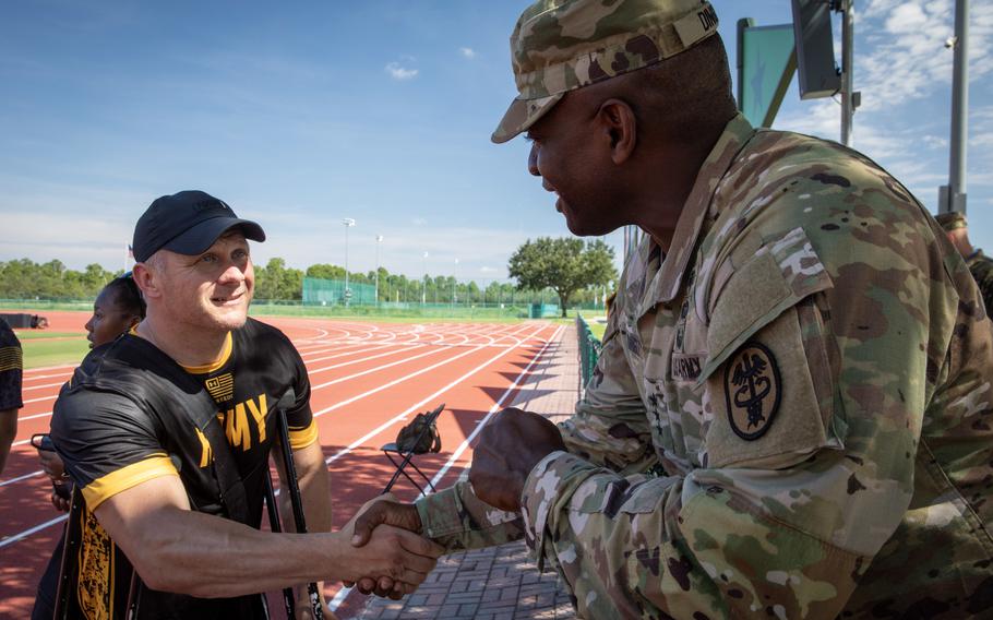 U.S. Army veteran Joshua Olson, left, meets with Lt. Gen. Scott Dingle Aug. 19, 2022, after on-court training for the Army team at ESPN Wide World of Sports Complex, Orlando, in Florida at the 2022 Department of Defense Warrior Games. 