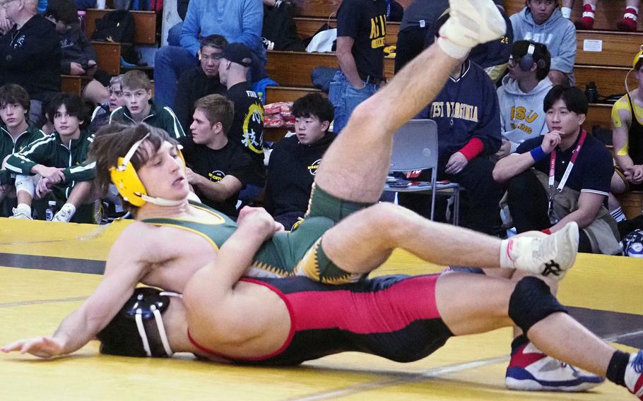 Nile C. Kinnick's Joseph Mauldin gut-wrenches Robert D. Edgren's Gabriel Marceron at 139 pounds during Saturday's Christian Academy Japan Invitational Tournament. Mauldin took first place.