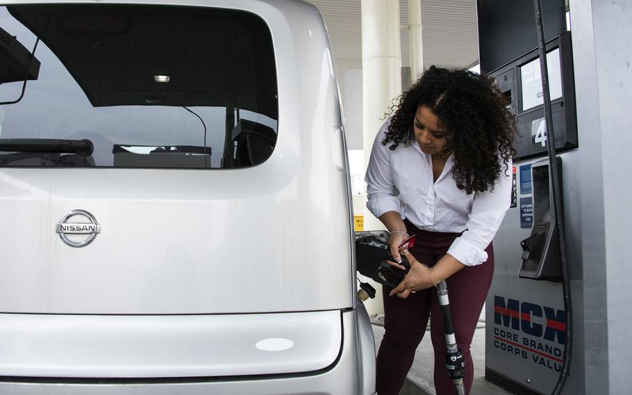 Navy spouse Rie Leverett fuels her vehicle at Marine Corps Air Station Iwakuni, Japan, Thursday, March 17, 2022.