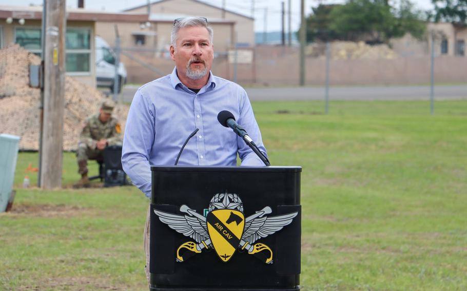 Kevin Yoakum speaks about Chief Warrant Officer 4 Keith Yoakum during a ceremony May 4, 2023, to rename an airfield at Fort Cavazos, Texas, in honor of his twin brother and Chief Warrant Officer 2 Jason DeFrenn. The two men died in combat in Iraq in 2007.