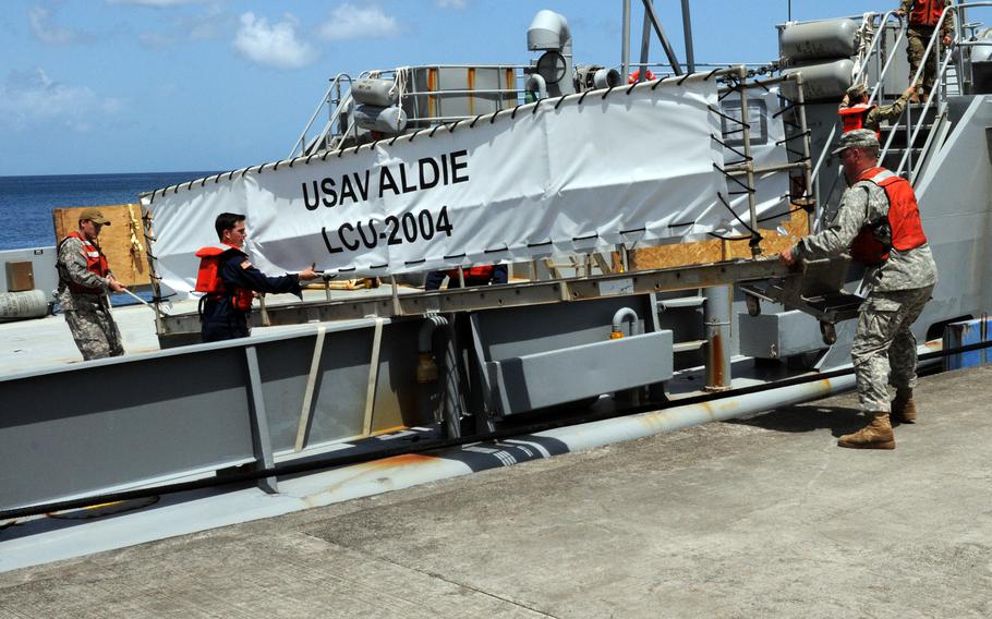 Soldiers get USAV Aldie, a landing craft, ready in Grenada for a training exercise in 2016. The Aldie and four other Army landing craft were identified by a commission to have their names scrubbed of references to the Confederacy, according to a report submitted to Congress on Monday, Sept. 19, 2022.