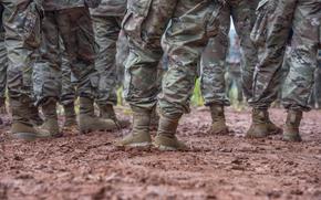 Clemson University's Army Reserve Officer's Training Corps held a contracting ceremony under a light rain during a field exercise in a muddy training area near the Clemson Experimental Forest, Sept. 16, 2021. Lieutenant Colonel Chad A. Monroe, Professor of Military Leadership, conducted the ceremony.  (Photo by Ken Scar)