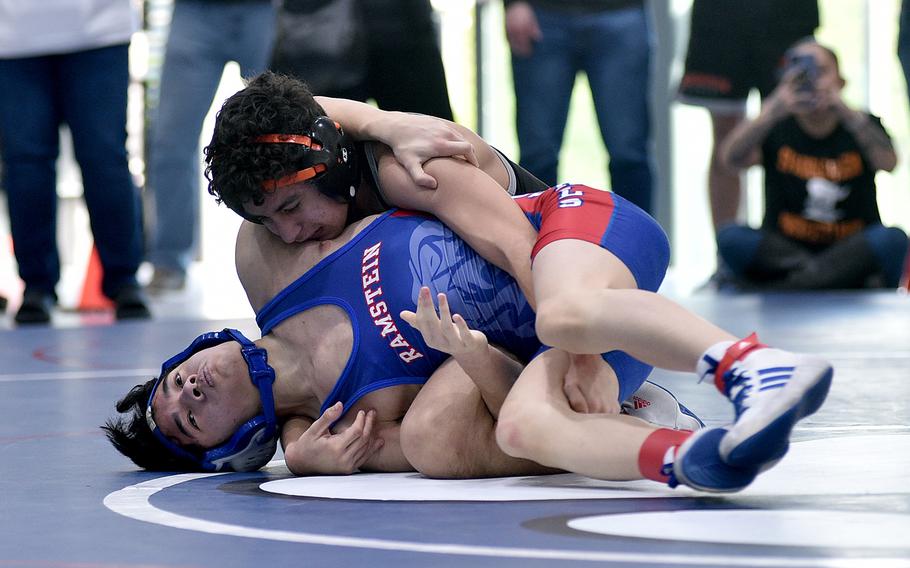 Spangdahlem's Andrew Molina and Ramstein's Cole Santos grapple during the 106-pound championship match on Saturday during the DODEA Central sectional wrestling tournament at Ramstein High School on Ramstein Air Base, Germany. Molina won, 17-12.