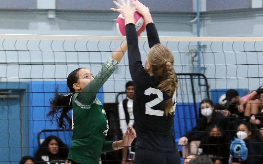Osan's Anne Mountcastle blocks a shot by Daegu's Izzy Thurman during Saturday's DODEA-Korea district girls volleyball tournament. The Cougars won the semifinal three sets to one over the Warriors, before losing in the final to Humphreys 3-1.