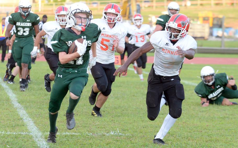 Kubasaki's Gavin McKnight tries to elude Nile C. Kinnick's Wendell Harrison.