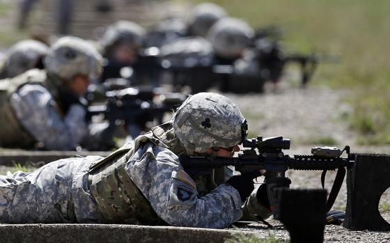 FILE - Female soldiers from 1st Brigade Combat Team, 101st Airborne Division train on a firing range while testing new body armor in Fort Campbell, Ky., Sept. 18, 2012. Female soldiers face rampant sexism, harassment and other gender-related challenges in male dominated Army special operations units, according to a report Monday, Aug. 21, 2023, eight years after the Pentagon opened all combat jobs to women. (AP Photo/Mark Humphrey, File)