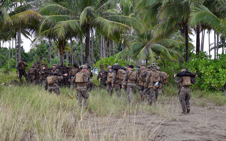 U.S. Marines depart entrenched positions in the jungle.