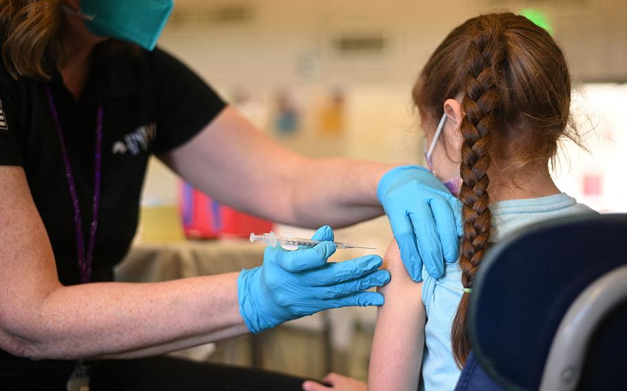 A nurse administers a pediatric dose of the COVID-19 vaccine to a girl at a L.A. Care Health Plan vaccination clinic at Los Angeles Mission College in the Sylmar neighborhood in Los Angeles, Jan. 19, 2022. 