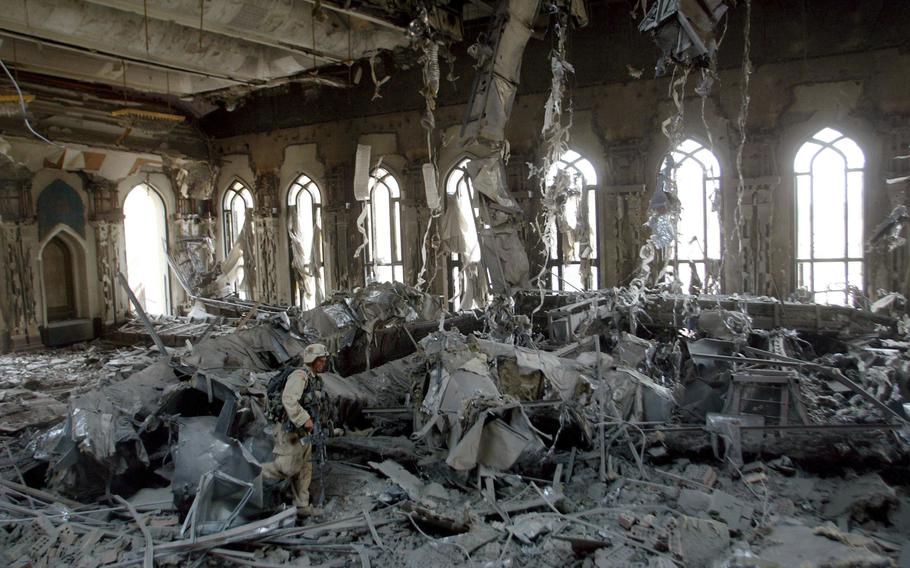 In this April 7, 2003, file photo, U.S. Army soldiers from A Company, 3rd Battalion, 7th Infantry Regiment, search one of Saddam Hussein's palaces damaged after a bombing in Baghdad. The U.S. launched its invasion of Iraq on March 20, 2003, unleashing a war that led to an insurgency, sectarian violence and tens of thousands of deaths.