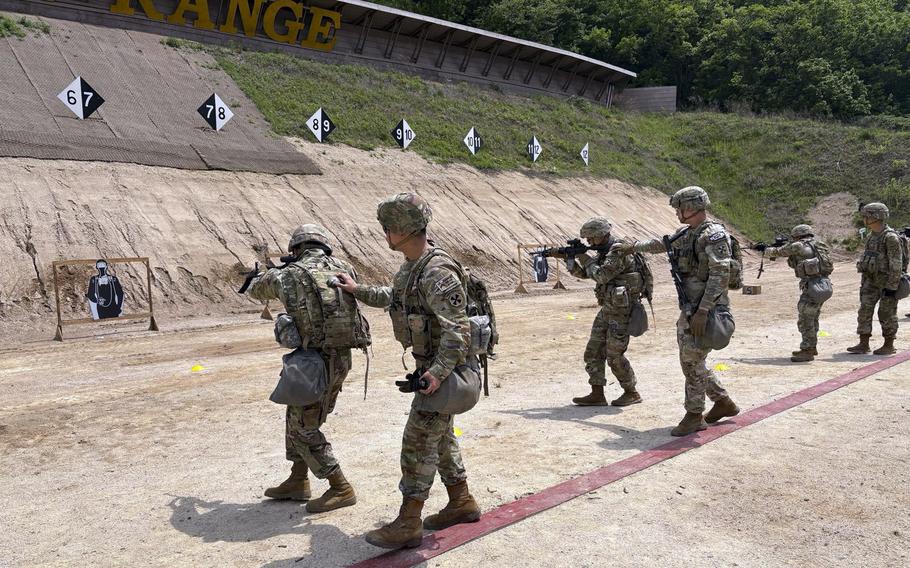 American and Korean soldiers fire at targets during day time shooting practice.