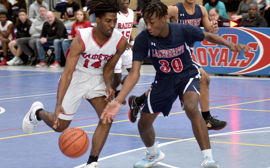 Kaiserslautern’s Akori Ford drives as Lakenheath’s Tre Maroney reaches in during pool play of the Division I DODEA European Basketball Championships on Wednesday at Ramstein High School on Ramstein Air Base, Germany.