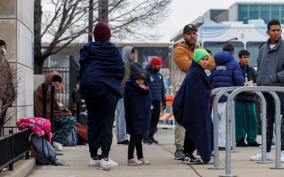 A group of migrants outside at the city’s migrant landing zone on Jan. 10, 2024.