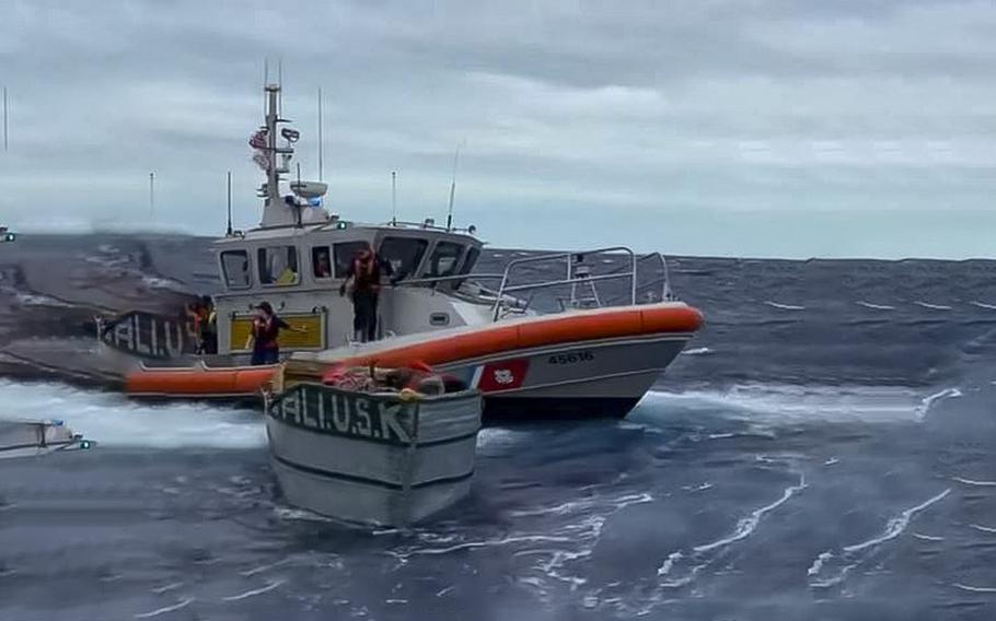 A video screen grab shows Coast Guard rescue crews beside a vessel used by migrants off Key West, Fla, as seen in a Mar 23, 2023, post.