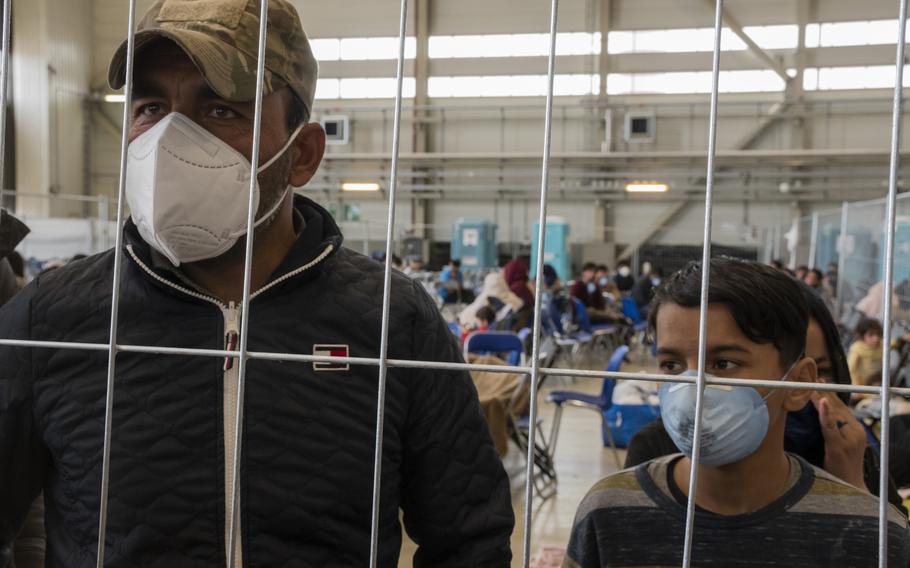 Rafiqullah Gharwal, left, waits to be flown with his family from Ramstein Air Base, Germany, to the United States on Aug. 30, 2021. Gharwal said he was happy to get the opportunity to leave Afghanistan and start a new life following the Talibans takeover of the country. 