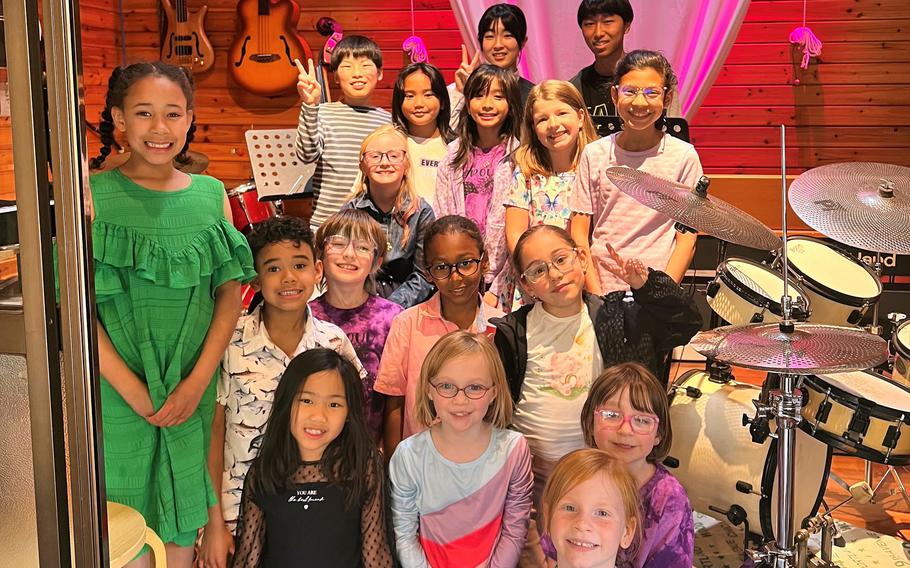 Children pose in a recording studio.
