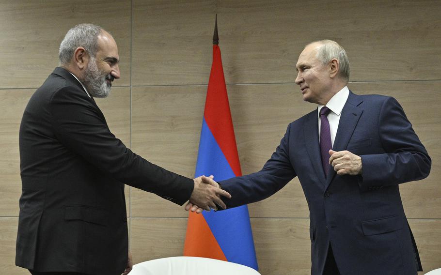 Russian President Vladimir Putin, right, and Armenian Prime Minister Nikol Pashinyan shake hands during their meeting in the resort city of Sochi, Russia, on June 9, 2023.