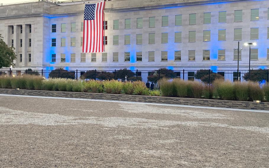 The Pentagon’s first event of the day was the flag unfurling, which took place at 6:47 a.m. The side of the building was lit up blue. There were a couple dozen people in attendance. Bagpipe players performed before the flag was unfurled. 