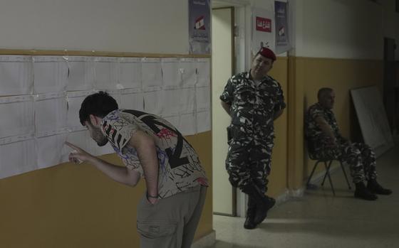 Lists of names at the polling station are affixed to a wall.