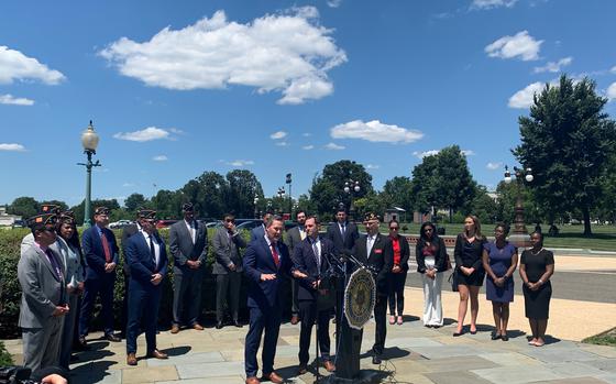 Reps. Michael Waltz, R-Fla., and Jason Crow, D-Colo., both Army veterans, stand beside members of the American Legion at a news conference Wednesday in front of the Capitol to urge President Joe Biden to evacuate Afghan interpreters and their families ahead of the full withdrawal of U.S. forces from Afghanistan.