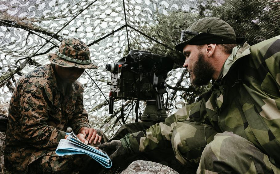 U.S. Marine Cpl. Armanjacob Celmar, left, and Staff Sgt. Jonas Ullmam, a Swedish marine, discuss simulated enemy positions during exercise Archipelago Endeavor 23 in Sweden on Sept. 11, 2023.