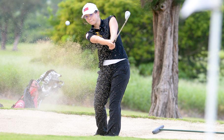 Defending champion Emma Conroy of Kadena blasts out of a bunker on the 206-yard, par-3 sixth hole. Conroy won the title for the second straight year.
