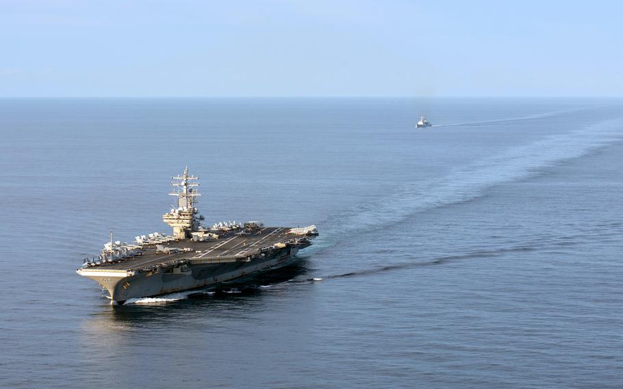 The aircraft carrier USS Ronald Reagan steams near the South Korean destroyer Munmu the Great in waters east of the Korean peninsula, Sept. 28, 2022.