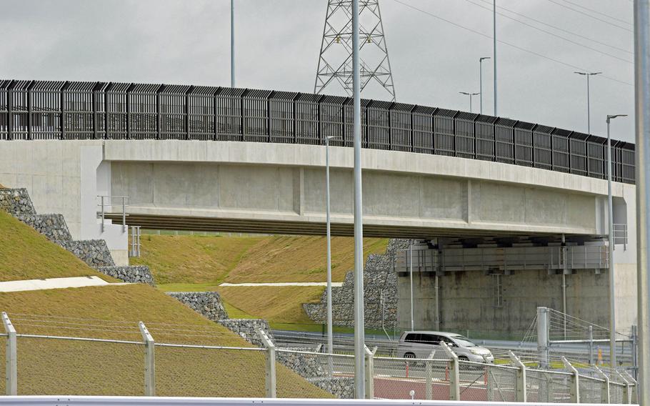 The new Gate 1 complex, which includes a guard shack, pass-and-ID office, a bridge over an 80-foot ravine, and north and southbound overpasses, directly connects Camp Hansen to the Okinawa Expressway via the Kin Interchange.