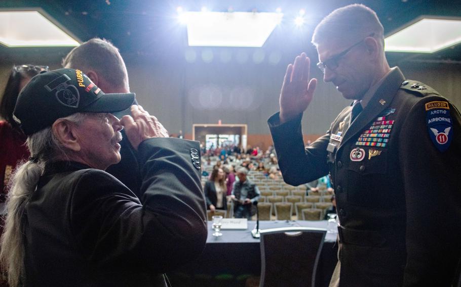 Benno Cleveland, founder Alaska Native Veterans Association, salutes Army Maj. Gen. Brian Eifler, deputy commander of Alaskan Command and commander of the 11th Airborne Division, during the Alaska Federation of Natives Annual Convention in Anchorage, Alaska, on Oct. 21, 2023. 