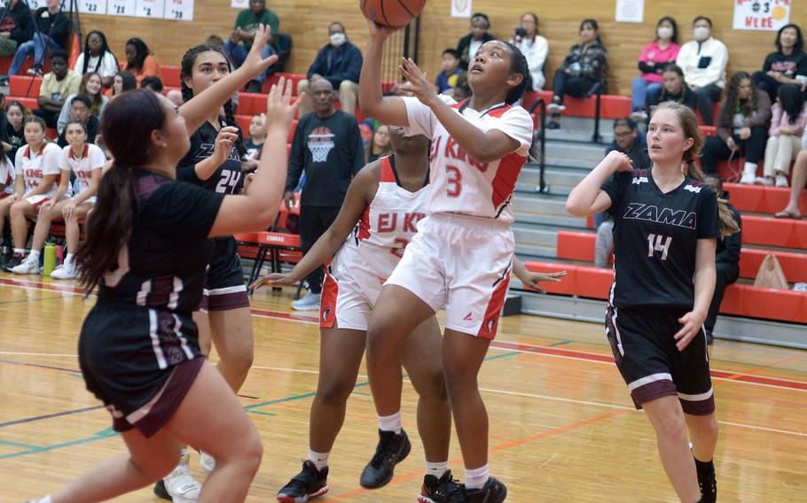 E.J. King's Moa Best shoots between Zama's Deborah McClendon and Lorelei Holt during Friday's DODEA-Japan girls basketball season-opening game. The Cobras won 69-33.