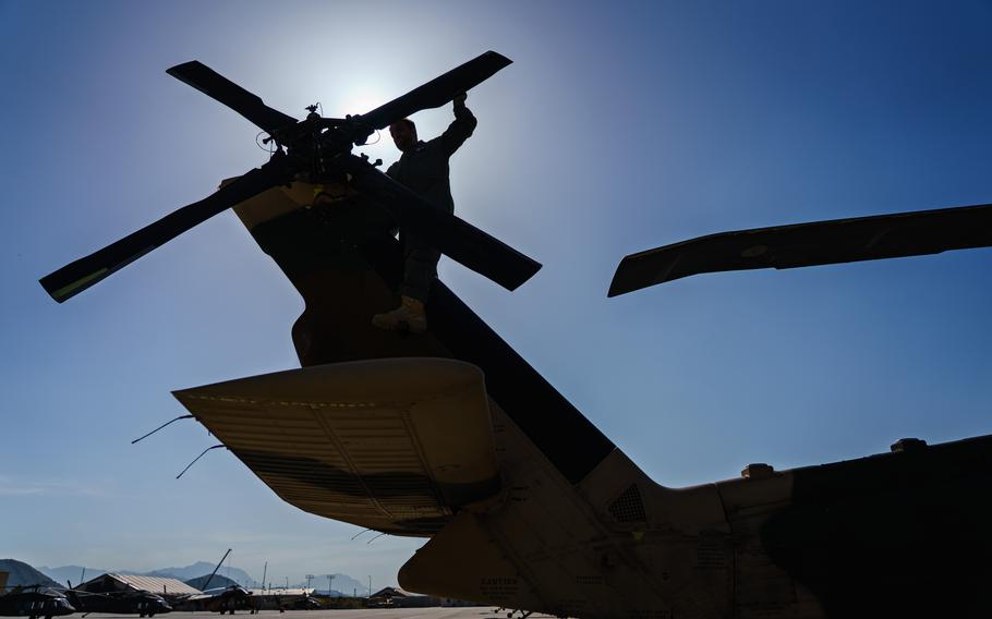 An Afghan air force UH-60 crew inspects the tail rotor during preflight check at Kabul Airbase in Afghanistan. 