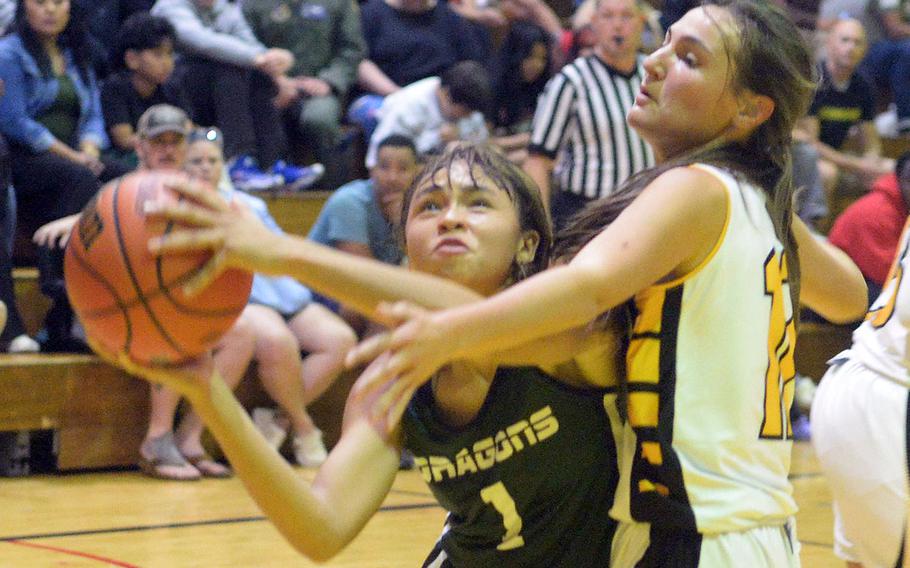 Kubasaki's Nevaeh Gilbert drives against Kadena's Kaitlyn Wetherington during Friday's DODEA-Okinawa girls basketball game. The Panthers won 44-40, leveling the season series 1-1.