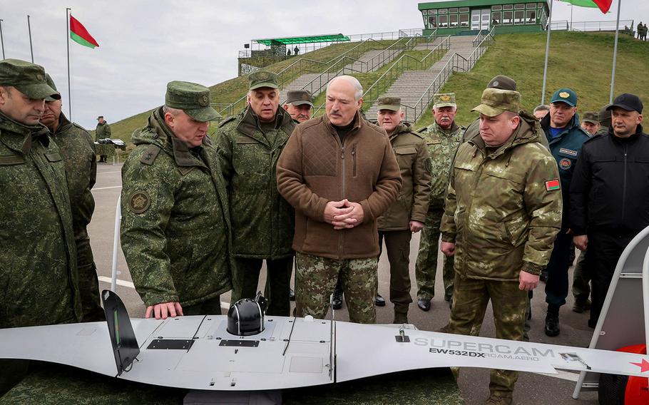 Belarusian President Alexander Lukashenko, center, inspects different types of weapons during his visit at the Obuz-Lesnovsky training ground, Belarus, on Friday, Oct. 21, 2022.