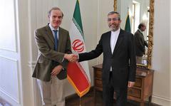 In this photo released by the Iranian Foreign Ministry, Enrique Mora, a leading European Union diplomat, left, shakes hands with Iran's top nuclear negotiator Ali Bagheri Kani in Tehran, Iran, March 27, 2022. Iran and the European Union said Wednesday, Aug. 3, 2022, that they would send representatives to Vienna amid what appears to be a last-ditch effort at reviving talks over Tehran's tattered 2015 nuclear deal with world powers.