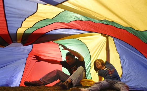 Ramstein, Germany, April 6, 2009: Ronnie Juhans, left, and Katt Gatke, 10, work to keep a parachute afloat during the first day of BRAT adventure camp Monday at Ramstein Air Base, Germany. Juhans is an outdoor adventure leader. Sixteen youngsters are spending a week during their spring break kayaking, rock climbing and learning the fine art of teamwork during the event, put on by Outdoor Recreation. 

Read the story and see additional photo here.
https://www.stripes.com/news/ramstein-youths-embark-on-brat-outdoors-adventure-1.90003

META TAGS: Basic Recreation Activity Training; BRAT; military family; outdoor recreation; dependents; DODDS; DODEA; 