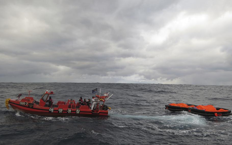 In this photo provided by the Korea Coast Guard, a South Korea coast guard vessel conducts a search operation in waters between South Korea and Japan, Wednesday, Jan. 25, 2023. South Korean and Japanese coast guards were searching for crew members of a cargo ship that sank in waters between South Korea and Japan, South Korean officials said.
