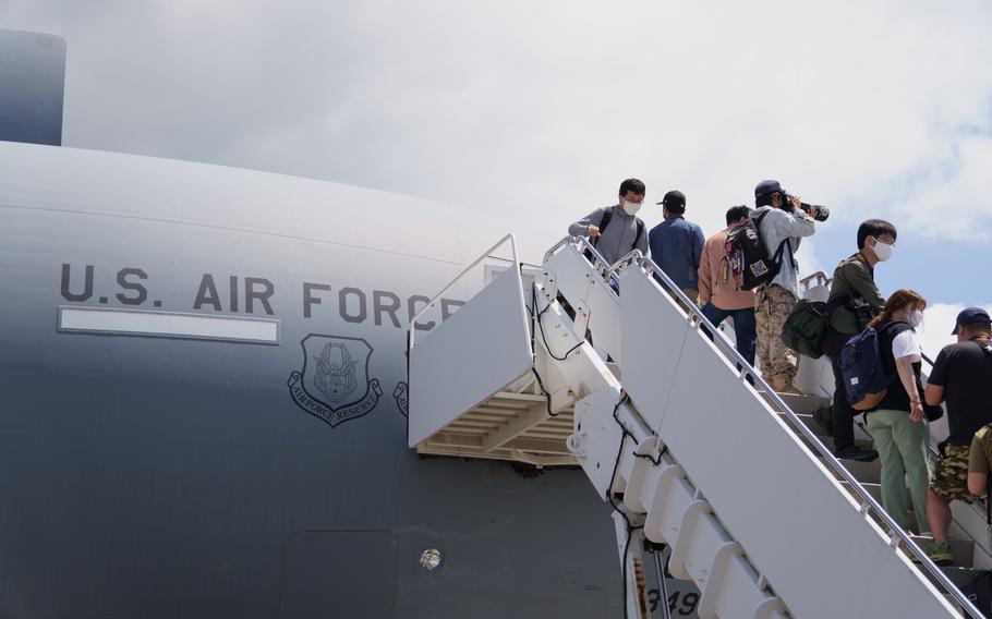 People line up to see inside an Air Force plane during the Friendship Festival at Yokota Air Base, Japan, Sunday, May 22, 2022.