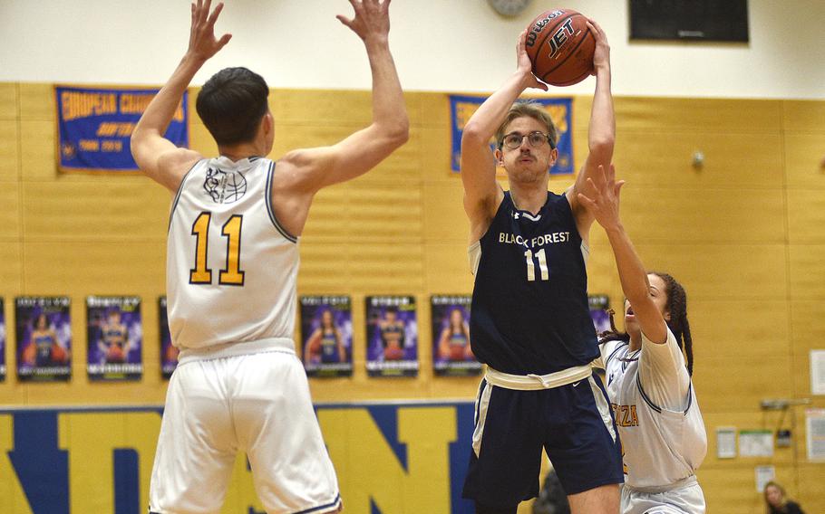 Black Forest Academy senior Barney Sivonen shoots as Ben Harlow defends during a Division II semifinal at the DODEA European Basketball Championships on Feb. 16, 2024, at Wiesbaden High School in Wiesbaden, Germany.