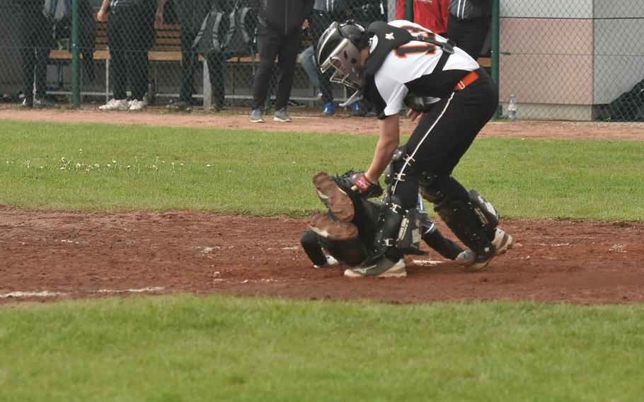 Spangdahlem catcher Andre Danielson tags out Wiesbaden’s Ryan Maraccini in Wiesbaden, Germany on April 20, 2024.  Maraccini was attempting to score.