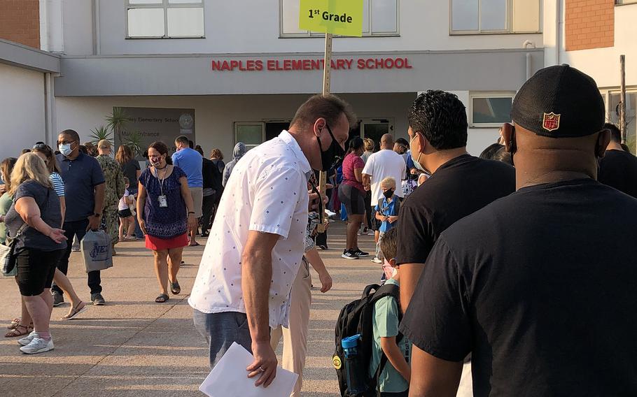 Teachers, parents and children line up outside Naples Elementary School on the Gricignano di Aversa site of Naval Support Activity Naples on Monday, Aug. 23, 2021.  