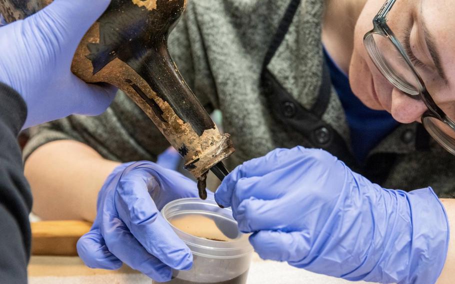 Archaeological Analyst Alice Keith extracting the contents of one of the approximately 250-year-old bottles recently unearthed at Mount Vernon. 