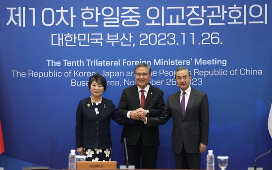 Chinese Foreign Minister Wang Yi, right, South Korean Foreign Minister Park Jin, center, and Japanese Foreign Minister Yoko Kamikawa pose for a photo prior to the trilateral foreign ministers' meeting in Busan, South Korea, Sunday, Nov. 26, 2023. (AP Photo/Ahn Young-joon, Pool)